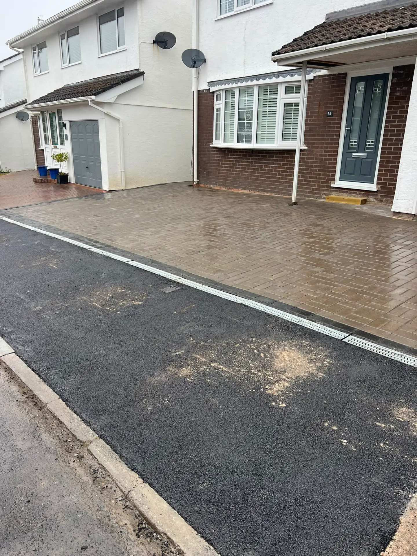 Block paved driveway with tarmac apron and drainage channel